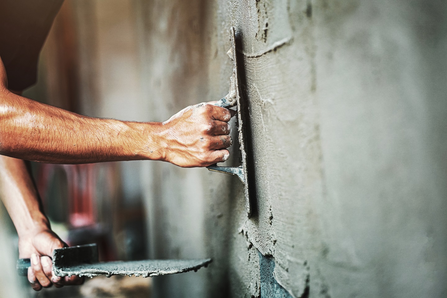 Closeup,Hand,Of,Worker,Plastering,Cement,At,Wall,For,Building