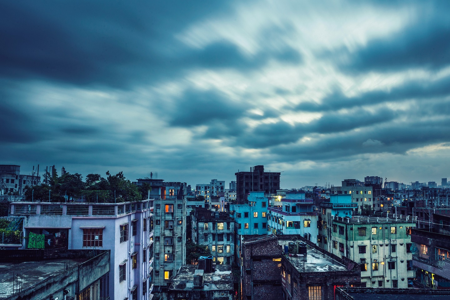 A bright blue sky and city buildings in Dhaka