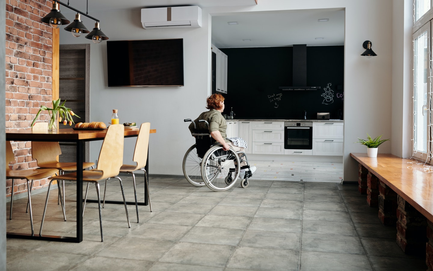 a person in a wheelchair is moving around a house