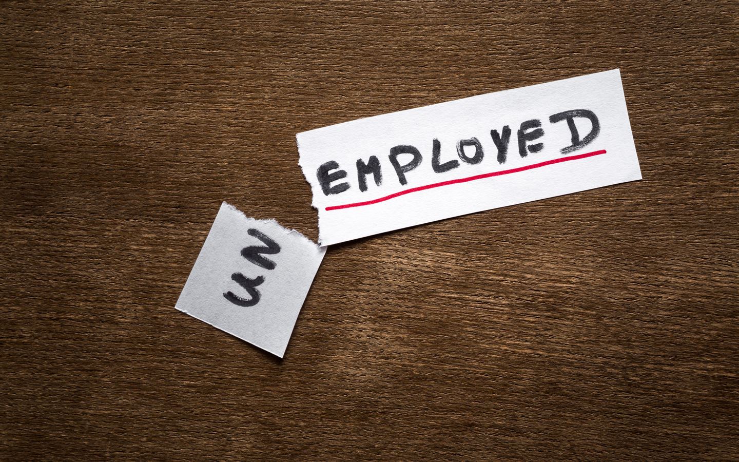 piece of paper with unemployement written on it