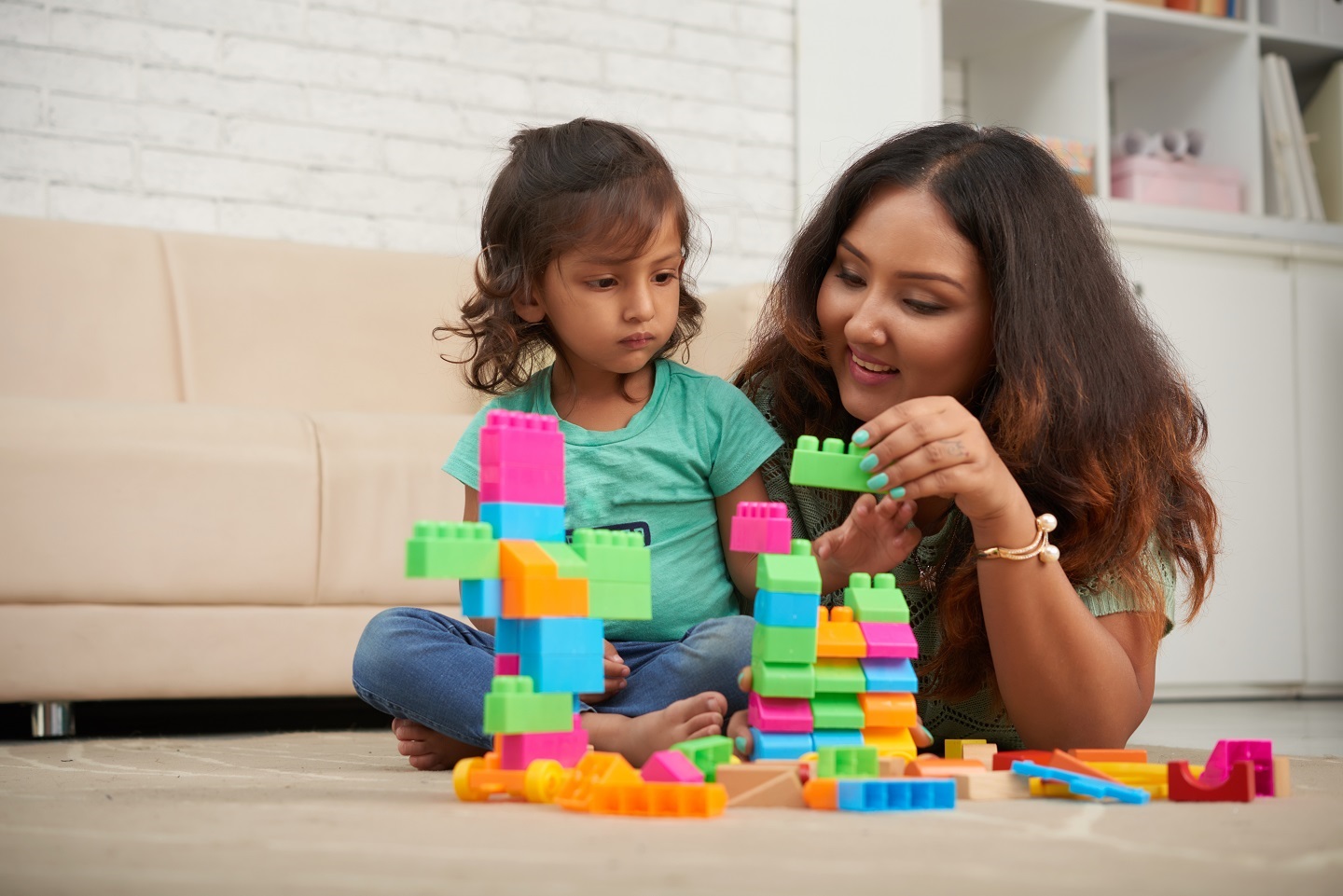 mother and daughter playing with blocks